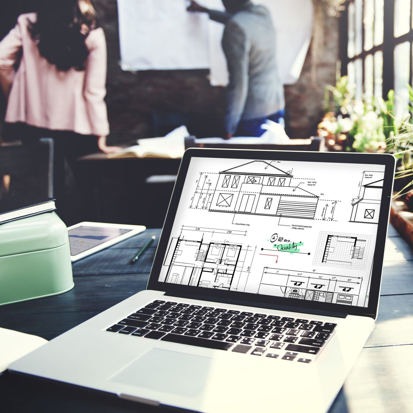 Construction blueprint and project documentation on a laptop